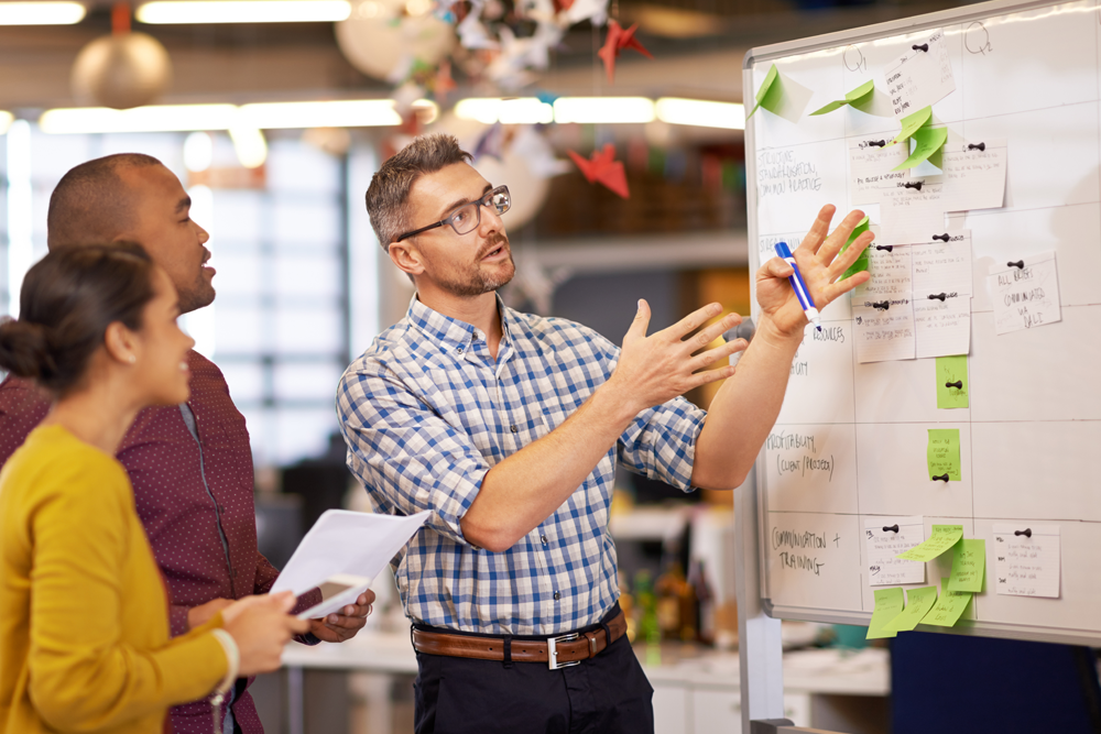 Architects designing on a mobile whiteboard