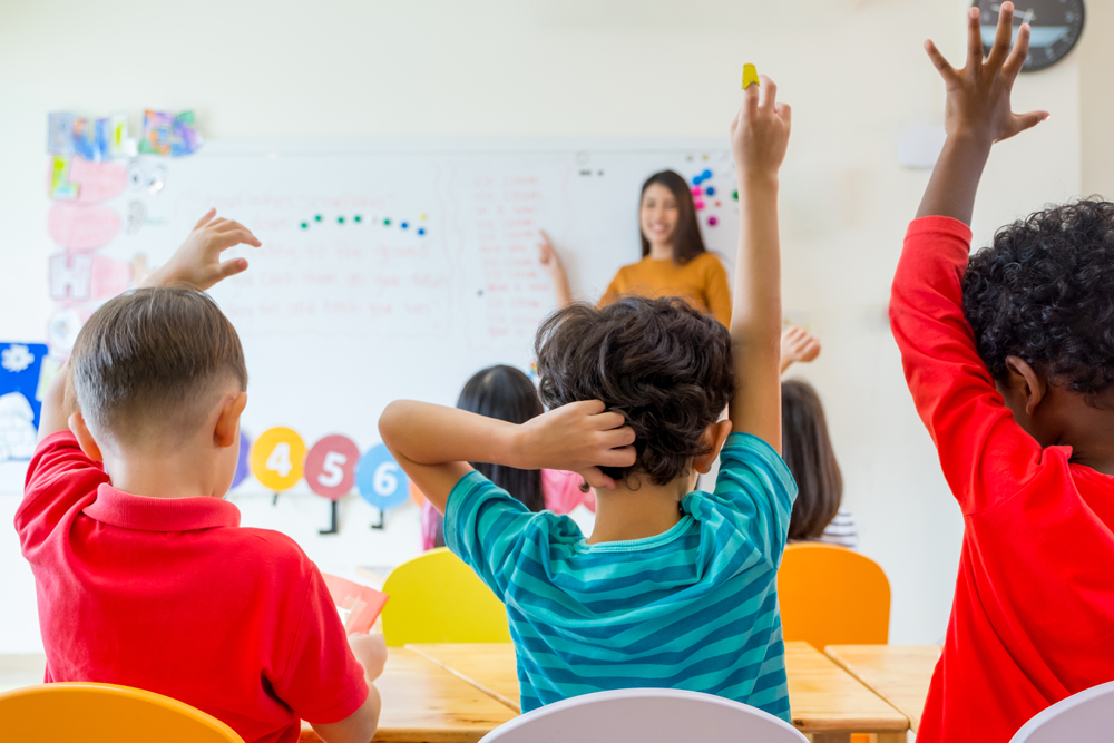 Children learning on classroom whiteboard